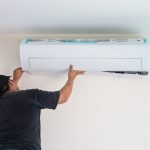 Man,Worker,Installs,Indoor,Air,Conditioner,In,The,New,Home.